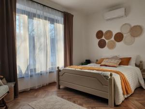 a bedroom with a bed and a large window at Tóparti Idill Vendégház in Kisszékely +43 photos