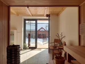 a kitchen with a glass door leading to a patio at Tóparti Idill Vendégház in Kisszékely