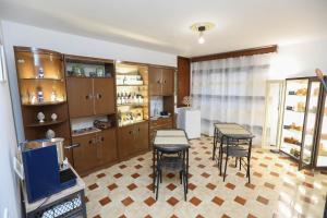 a room with two tables and chairs and a tv at Pianofilecciarooms in Salemi