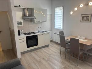 a kitchen and dining room with a table and chairs at House 149 in Ferrara +19 photos