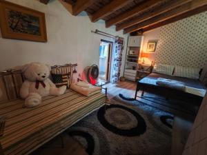a teddy bear sitting on a bed in a room at Vila Topalli in Pogradec