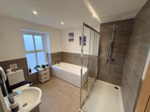 a bathroom with a shower and a toilet and a sink at The Farm House in Skipton +42 photos