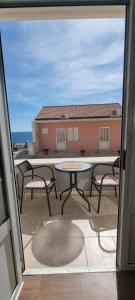 a view of a patio with a table and chairs at Matea Apartments Milna in Milna