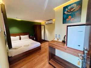 a bedroom with a bed and a large screen television at Al Bayan Palms in Nizwa +40 photos