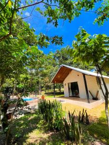 a small white building with a roof at Bosque dos Buritis in Araguaína
