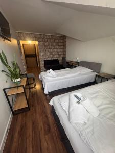 a hotel room with two beds and a table at Polonez w Rymaniu in Rymań +62 photos