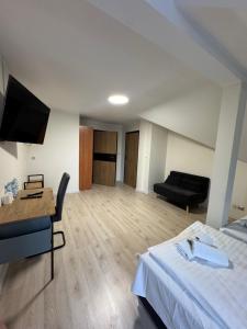 a hotel room with a bed and a couch at Polonez w Rymaniu in Rymań