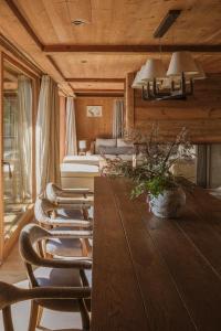 a living room with a table and chairs and a couch at L'Alpaga, a Beaumier hotel in Megève