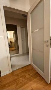 an empty room with a door and a mirror at CL Home Lux in Podgorica