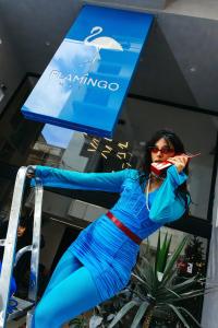a woman is standing under a sign at Flamingo Hotel Malta in St. Julianʼs