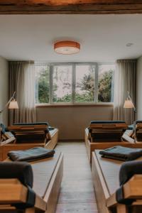 a room with rows of chairs and windows at Strasserwirt - Ansitz zu Tirol in Strassen