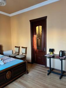 a bedroom with a bed and a table and chairs at Villa Jakos Paradise in Batumi +72 photos