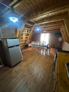 a large room with a kitchen and a dining room at Ventana al Champaqui in Yacanto +12 photos