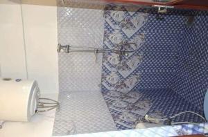 a bathroom with a shower curtain and a toaster at Manimalar guest in Colombo