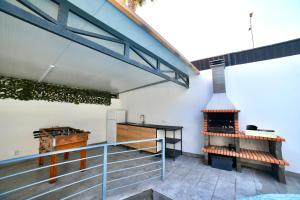 an outdoor kitchen with an outdoor oven and stairs at Villa Alvor in Alvor
