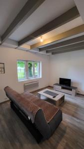 a large room with a bed and a table at Ma Location Saisonnière in Chasseneuil-du-Poitou +62 photos