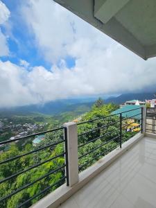 a balcony with a view of a city at Seasons Hotel in Lunglei