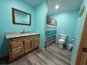 a bathroom with a sink and a toilet at Cass Lake Lodge in Cass Lake