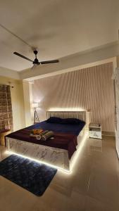 a bedroom with a bed in a room with a ceiling at OhanaStay02 in Guwahati