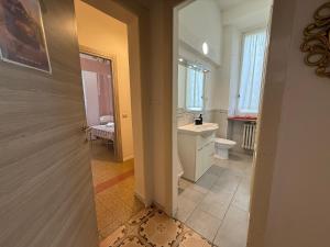 a bathroom with a sink and a toilet at La Gardenia del ducato in Parma +19 photos