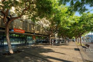 a tree lined sidewalk in front of a building at easyHotel Barcelona Fira in Hospitalet de Llobregat