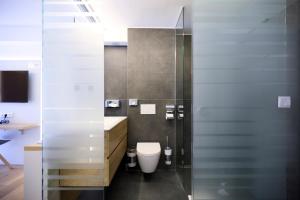 a bathroom with a toilet and a sink at Evermore Nürnberg - Fürth in Fürth +41 photos