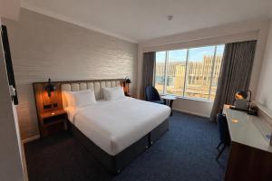 a hotel room with a bed and a large window at Radisson Blu Hotel, Durham in Durham