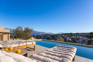 a patio with couches and a swimming pool at Lemon Tree Villa in Splitska