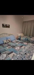 a bedroom with two beds with a quilt on them at Eagles guest house Piet Retief in Piet Retief