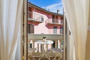 a view from a balcony with a table and chairs at Casa Scioli in Caraglio
