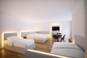 a hotel room with two beds and a desk at Evermore Nürnberg - Fürth in Fürth