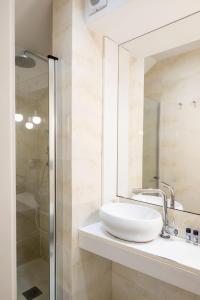 a bathroom with a sink and a shower at Terro Collection - Alcaide in Braga