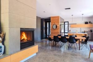 a living room with a fireplace and a table and chairs at SpaHaus #128 in Lac-Superieur +49 photos