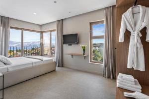 a bedroom with a bed and a large window at Lemon Tree Villa in Splitska +33 photos