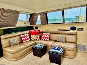 a living room with a couch in a boat at Relation Ship in Onekama