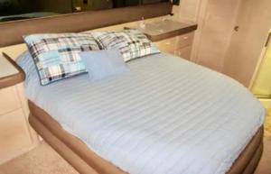 a bed with two pillows on top of it at Relation Ship in Onekama