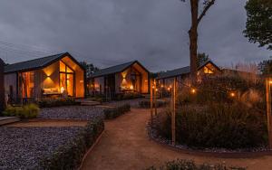 a house with lights in front of it at night at Tinyhouse luxe met privé hottub in Meerssen