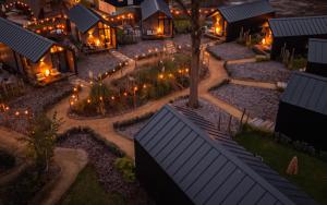 an aerial view of a home at night with lights at Tinyhouse luxe met privé hottub in Meerssen
