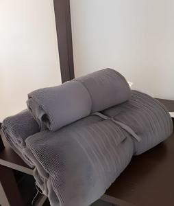 a stack of pillows sitting on top of a bed at Bunowen, Louisburgh, Walk to the Beach! in Louisburgh