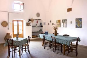 a dining room with a blue table and chairs at Terra di Leuca in Salve