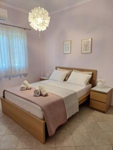 a bedroom with a bed with towels on it at B&B one in Vonitsa