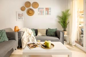 a living room with two couches and a coffee table at Gran Sol 3BR - Sea View - AC & Wifi - 10 min to Beach in Rincón de la Victoria