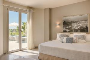 a bedroom with a bed and a sliding glass door at Villa Felicity in Svoronata +38 photos