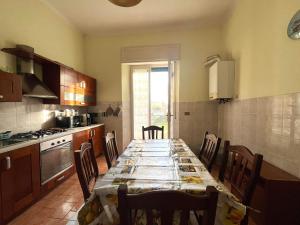 a kitchen with a long table with chairs in it at Villa Mehari in Pisa +56 photos