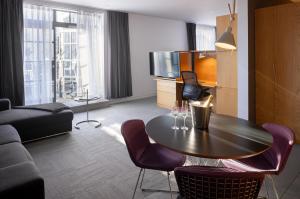 a living room with a table and a couch at Hotel Gault in Montreal