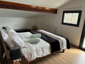 a bedroom with a bed with white sheets and pillows at Casa Vilariça in Alfândega da Fé