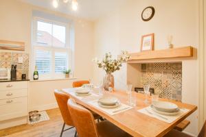 a kitchen and dining room with a table and chairs at Northern Hideaways, Darling Cottage in Seahouses +67 photos