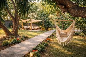 a hammock hanging from a tree in a garden at Villa Corocael in Castellabate