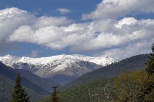 a mountain with snow covered mountains in the distance at Ortevani Guest House in Kvareli