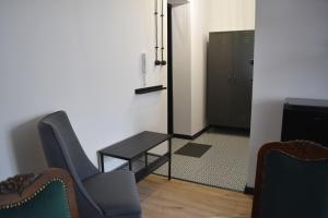 a room with two chairs and a table and a door at LOFT Jana z Kolna in Koszalin